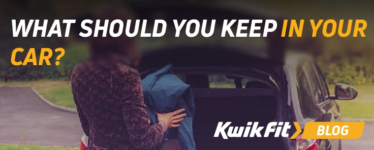 Someone putting a jacket in the boot of a car